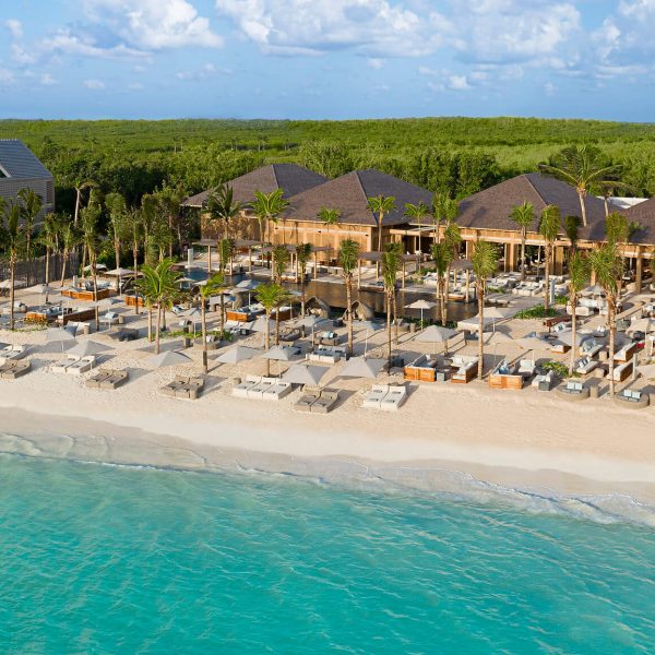 beach club cabanas line white-san beach on caribbean ocean